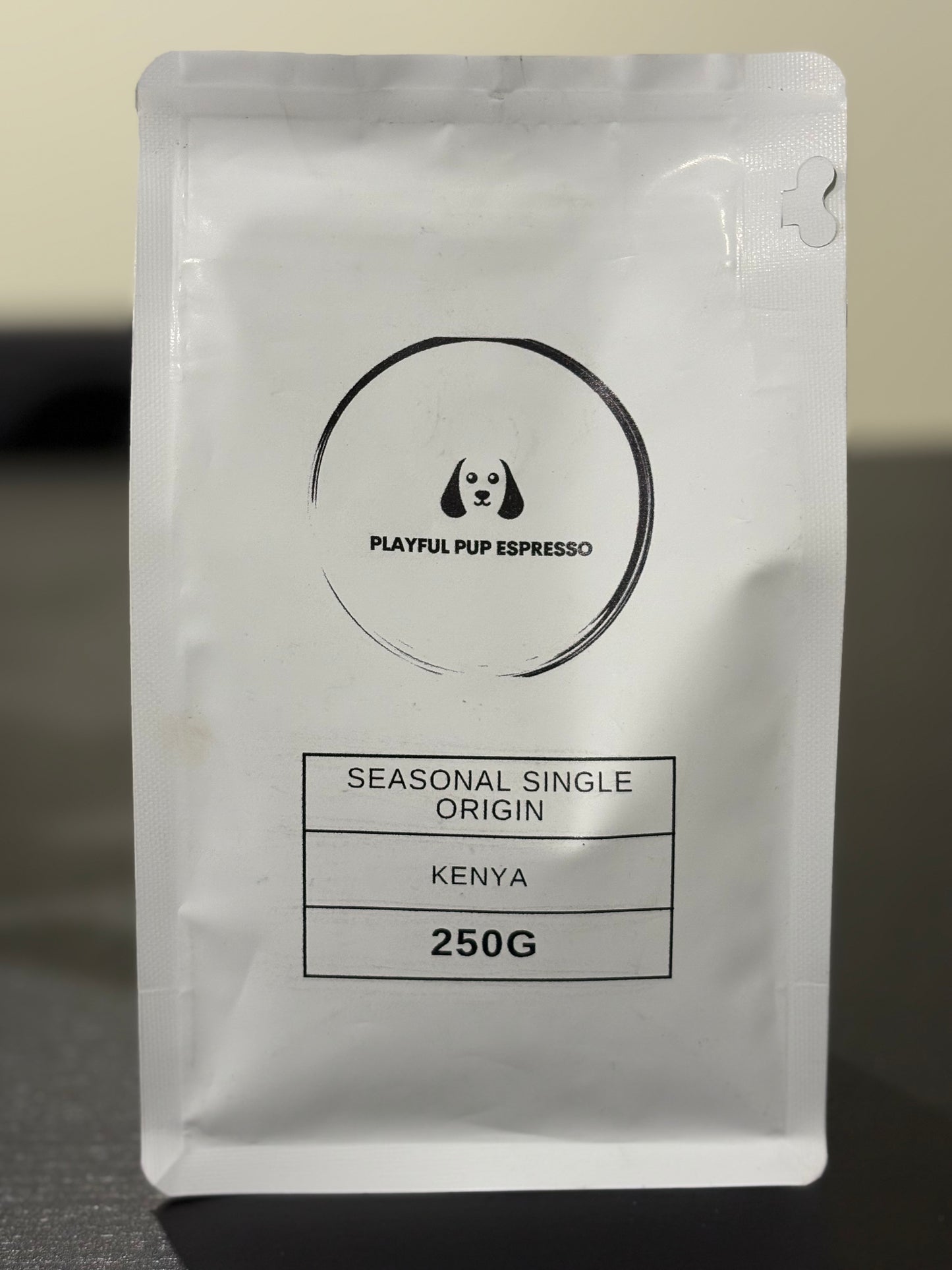 Playful Pup Espresso coffee package on a dark surface