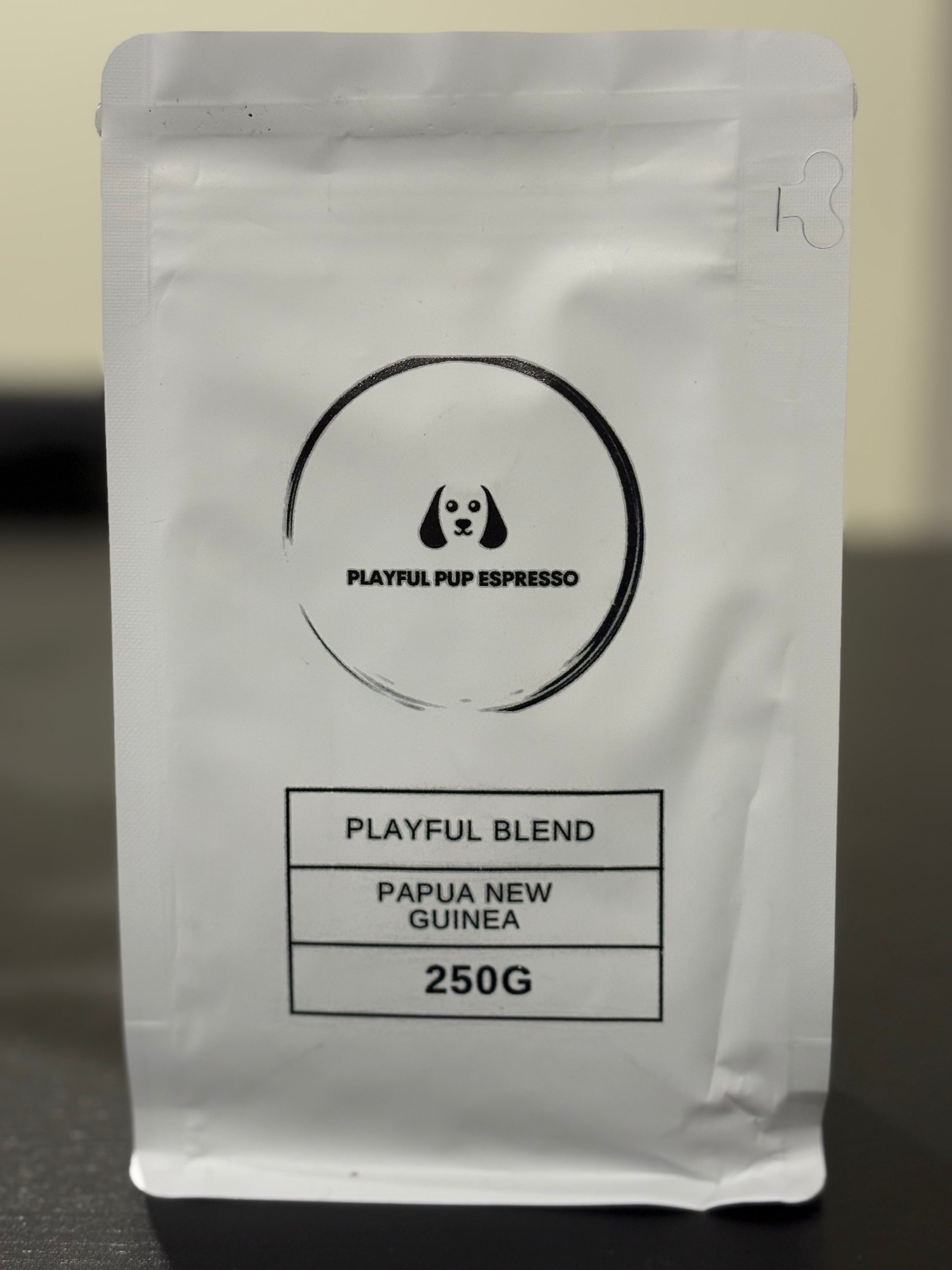 Coffee package labeled 'Playful Pup Espresso' with branding and product details.